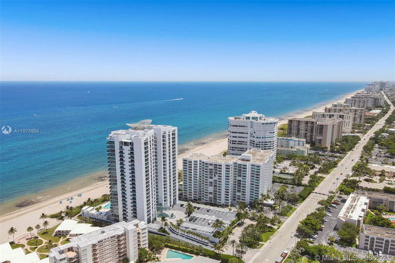 Aerial view of beachfront high-rise buildings overlooking the ocean.