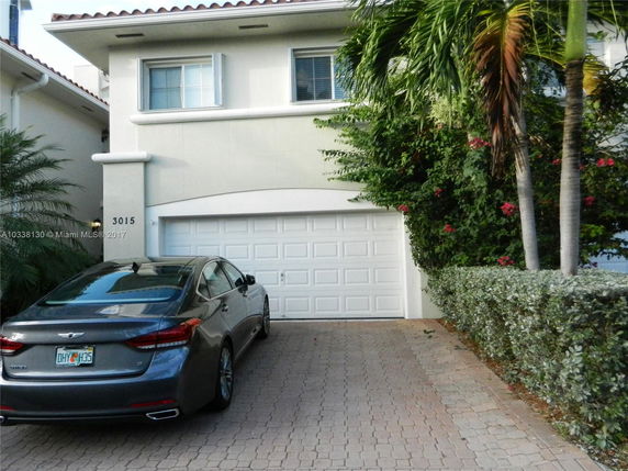 Front view of a two-story house with a single garage and a driveway.
