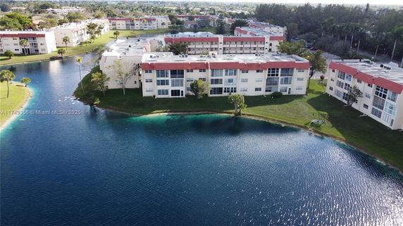 Aerial view of a series of residential buildings near a large body of water.