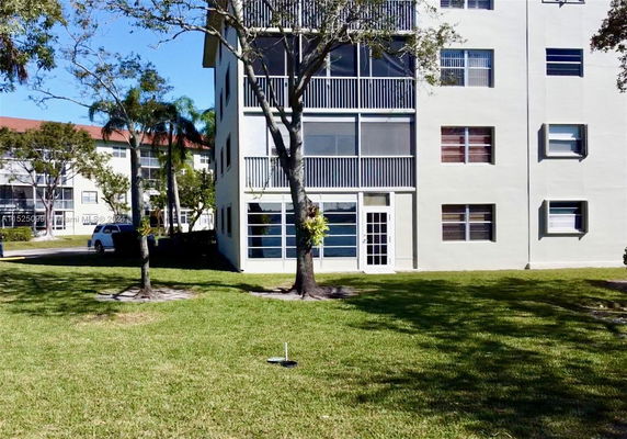 Front view of a multi-story apartment building with balconies.