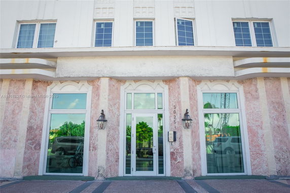 Front view of a building with large windows and decorative facade.