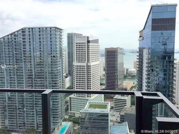 Panoramic view of city buildings seen from a high vantage point.