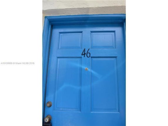 Close-up view of a blue door with the number 46.