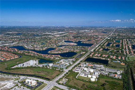 Panoramic aerial view of a city with residential areas, roads, and water bodies.
