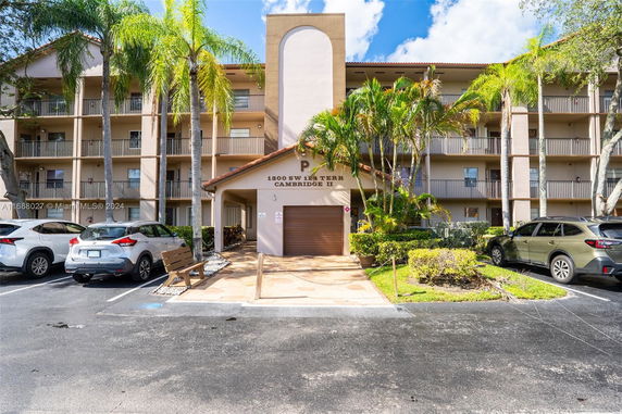Front view of a multi-story residential building with balconies.