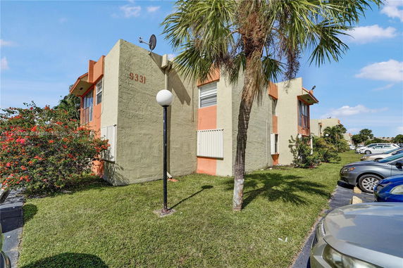 Front view of a two-story building with textured exterior walls, numbered 9331.