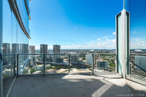 Balcony view overlooking a cityscape with modern high-rise buildings.