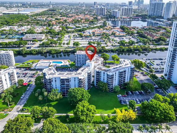 Aerial view of a residential area with multiple apartment buildings and a canal.