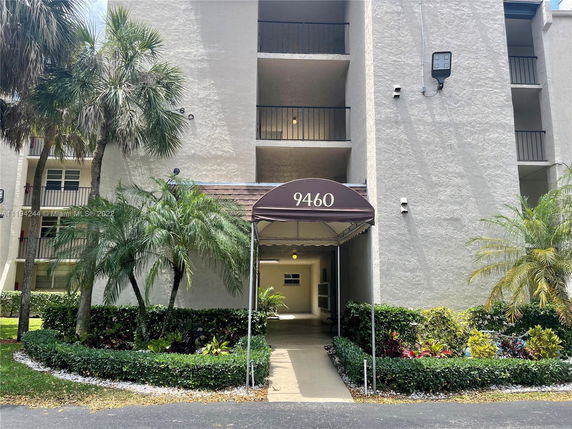 Front view of a multi-story building entrance with balconies.