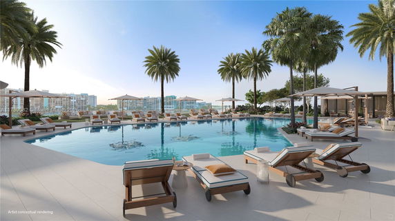 Luxurious outdoor swimming pool area with lounge chairs and umbrellas surrounded by palm trees.
