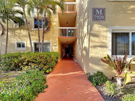 Front view of a multi-story residential building with balconies.