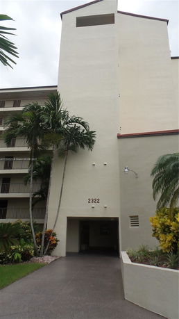 Front view of a multi-story building with a covered entrance.