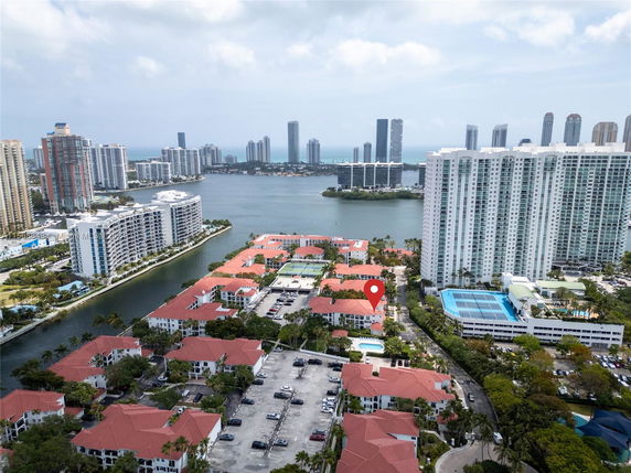 Aerial view of a cityscape with high-rise buildings and waterways.