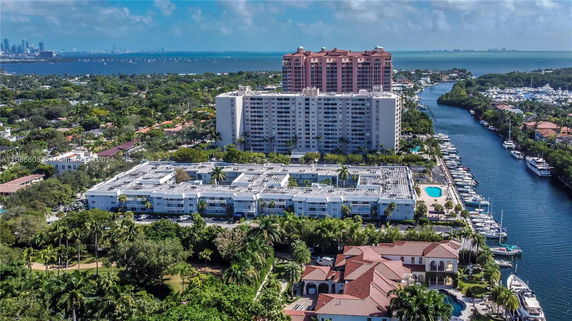Aerial view of a residential area with waterfront buildings and boats.