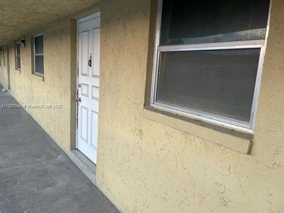 View of a building exterior with a door and windows.