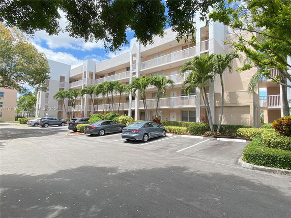 Front view of a multi-story residential building with balconies.