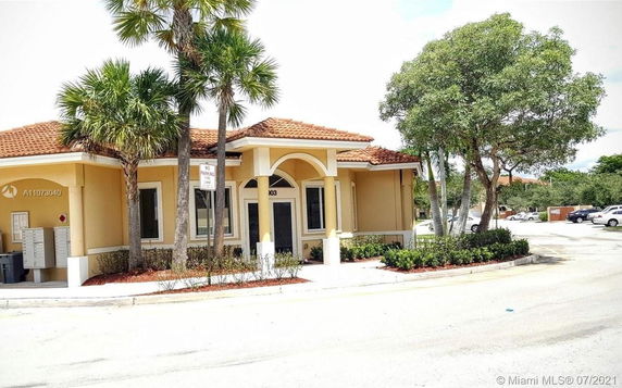 Front view of a single-story building with a tiled roof and covered entrance.