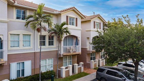 Front view of a multi-story residential building with small balconies.