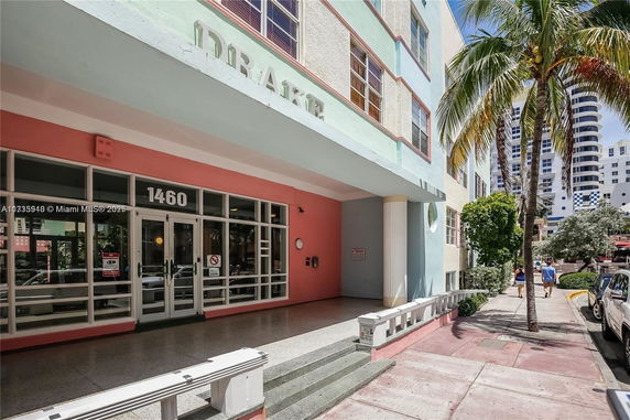 Front view of a pastel-colored building with wide entrance doors.
