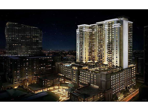 Night view of illuminated high-rise buildings with multiple stories.
