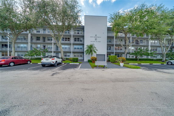 Front view of a multi-story residential building with balconies.