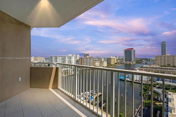 View from a balcony overlooking buildings and waterway.