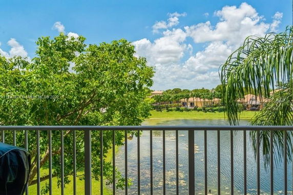 View of trees and water from a balcony.