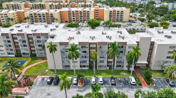 Aerial view of a multi-story apartment complex with multiple buildings and parking lots.