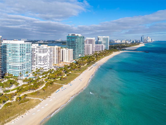 Panoramic view of beachfront high-rise buildings along the coast.