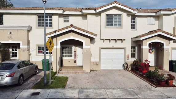Front view of a townhouse with an attached garage.