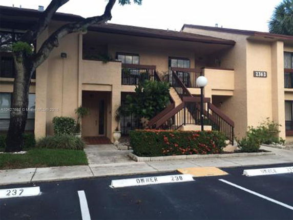 Front view of a two-story building with external staircase.