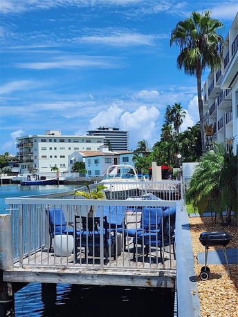 View of a building with a waterfront deck and surrounding buildings.