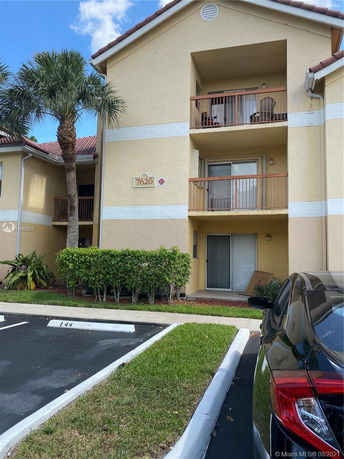 Front view of a multi-story apartment building with balconies.