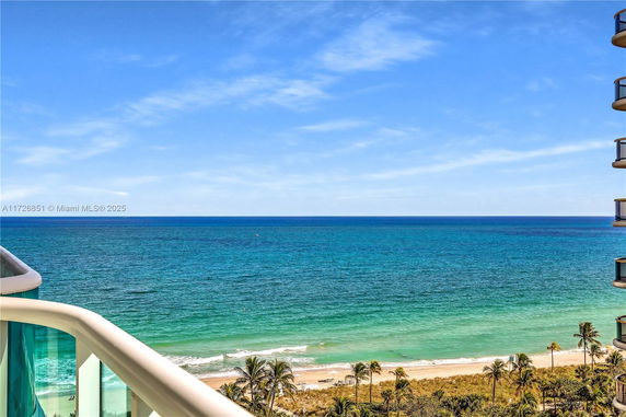 Panoramic view of the ocean from a building balcony.