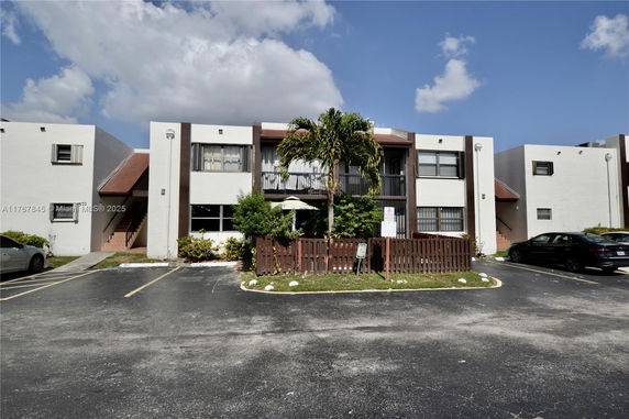 Front view of a two-story apartment building with balconies.