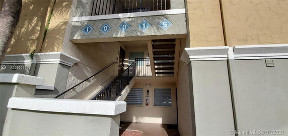 Entrance view of a building with stairs leading to a second level.