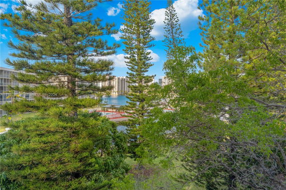 View of surrounding area with trees and buildings in the background.
