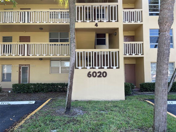 Front view of a multi-story building with balconies.