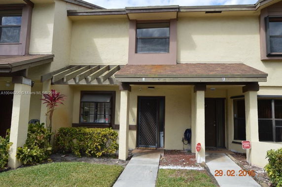 Front view of a two-story townhouse with adjacent units.