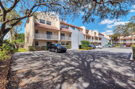 Parking area in front of a multi-story residential building