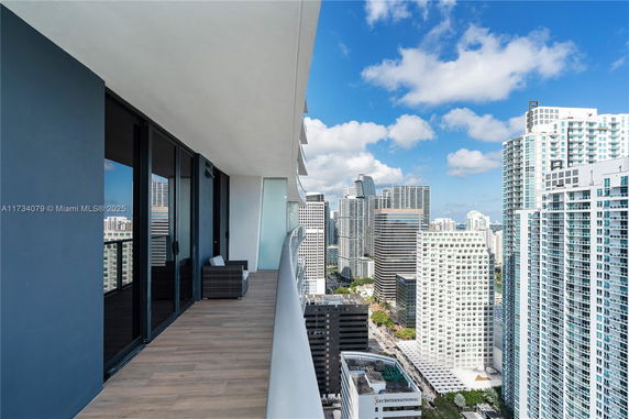 Balcony view overlooking city skyscrapers.
