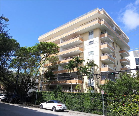Front view of a multi-story residential building with balconies.