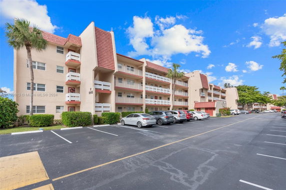Front view of a multi-story apartment building with balconies.