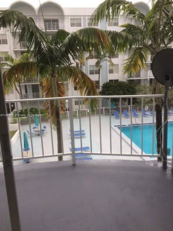 View of a swimming pool area from a balcony.