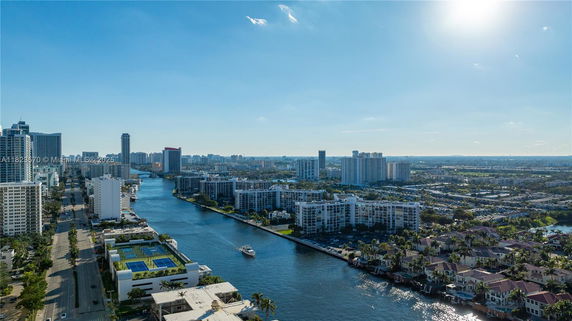 Panoramic view of a city skyline with waterways and high-rise buildings.