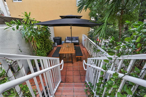 Outdoor patio area with seating and umbrella.
