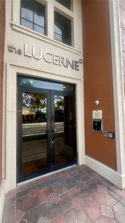 Front entrance of a building with glass doors and a sign reading 'the LUCERNE'.