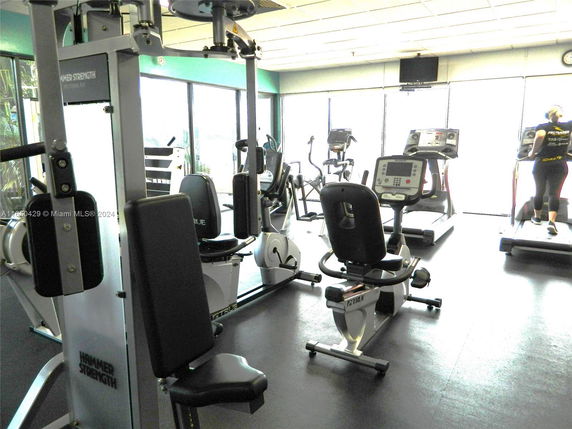 Interior view of a gym with various exercise equipment.