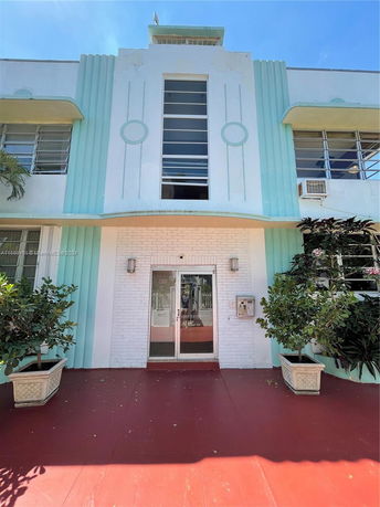 Front view of a building with art deco architectural details and a central entrance.