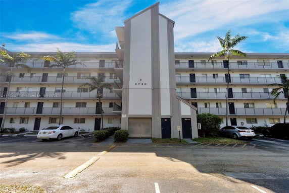 Front view of a multi-story apartment building with balconies.
